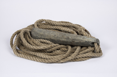 A large lead weight connected to a lenght of rope used by early mariners to deternibe the ocean depth beneath their vessel