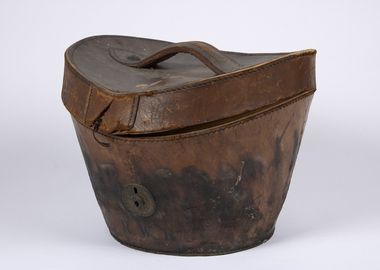 An ovel shaped leather hat box with R.W.R. inscribed below the lock.