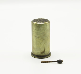 A brass match canister and one vesta match