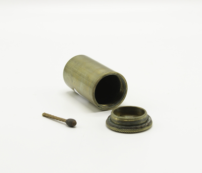 A brass match canister showing an open view and one vesta match