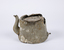 Aluminium teapot showing extensive damage, corrosion and encrustations. 