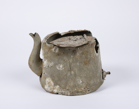Aluminium teapot showing extensive damage, corrosion and encrustations. 