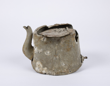 Aluminium teapot showing extensive damage, corrosion and encrustations. 