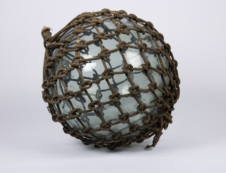 A glass float with original rope netting around it.