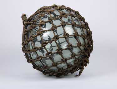 A glass float with original rope netting around it.
