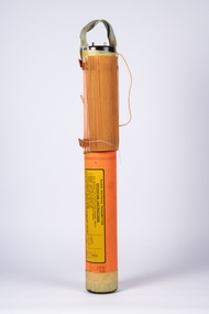 The cylindrical beacon transmitter is shown  out of its canvas bag. It consists of an orange canaster and wound up line.
