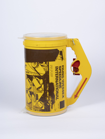 A yellow canister containing a firing charge and speed line rope with a handle and red firing trigger.