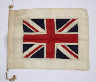 Small Union Jack on white backing fabric attached to a rope segment.