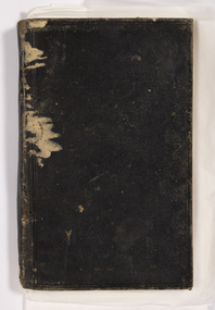 A black leather bound diary showing extensive damge to spine area