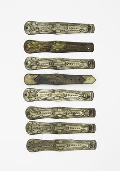 Eight pocket knive handle facias, some complete some incomplete tarnished or faded.