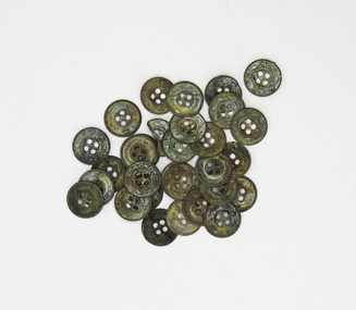 A collection of brass buttons, some damaged, tarnished and encrusted, recovered from the wreck of the Schomberg. 