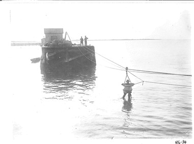 Black & white photograph of Rocket rescue practice with breeches buoy system