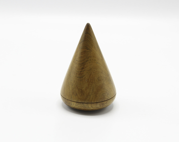 A timber cone shaped palm fid with smooth edges and groved design on base.