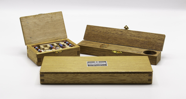 Three timber boxes containing compass correctors, shadow pins and magnets.