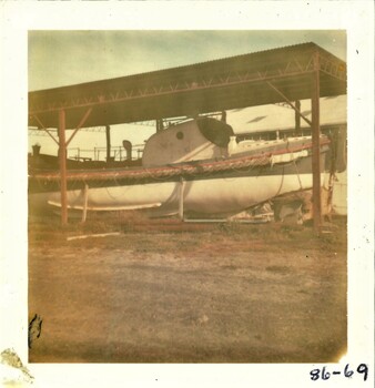 Colour photo of the Queenscliffe lifeboat under temporary cover at the QMM site