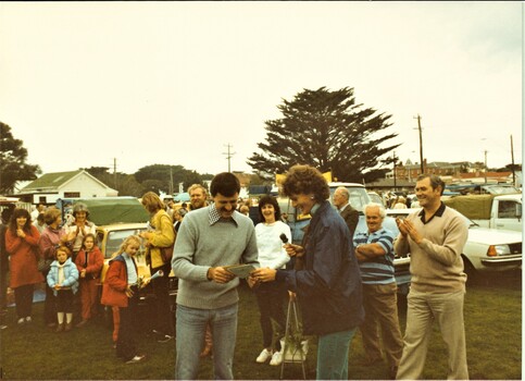 Colour photo of a Queenscliffe organisation's representative receiving a cheque from the market