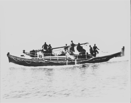 Black & white photo of the Lifeboat QUEENSCLIFFE under way & stepping the forward mast