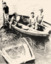 Black & white photo of old, sunken 'rescue' dinghy