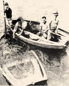 Black & white photo of old, sunken 'rescue' dinghy