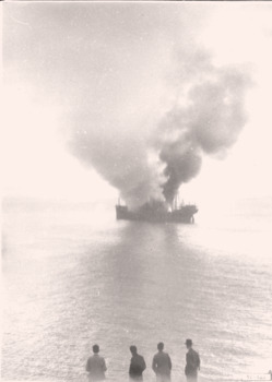Long distant  photo of the SS Orungal on Eastern Reef, alight.