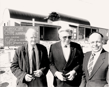 3 guests outside QMC c1985 during construction.