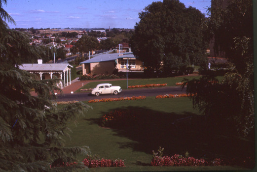 A holden car going up a hill besides a park