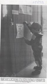 Photograph - BENDIGO ADVERTISER COLLECTION: SMALL CHILD ATTACHING A NOTICE TO A DOOR