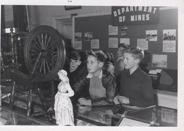 Photograph - GOLDEN DAYS HISTORICAL EXHIBITION COLLECTION: CHILDREN LOOKING AT SPINNING WHEEL