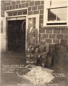 Photograph - BILL ASHMAN COLLECTION: TWO MEN OUTSIDE BUILDING WITH A SCALEBUOY
