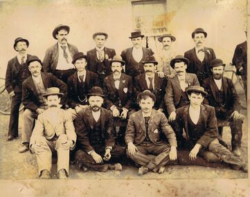 Photograph - GROUP OF MEN IN FRONT OF BUILDING