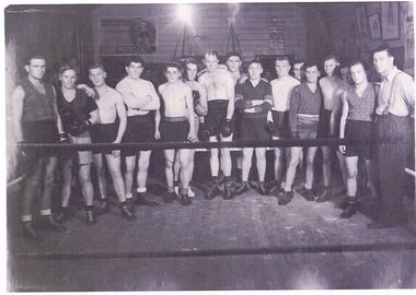 Photograph - GROUP PORTRAIT:  16 MEN DRESSED IN TRAINING ATTIRE IN BOXING RING
