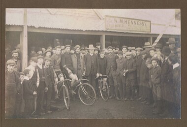 Photograph - GROUP OF MEN AND BOYS IN FRONT OF WM HENNERSEY'S