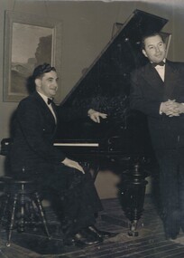Photograph - TWO MEN POSING BESIDE GRAND PIANO