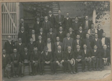 Photograph - GROUP OF MALES IN FRONT OF WOODEN BUILDING, Early 1900's