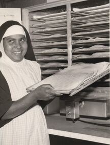 Photograph - POOR CLARE COLLECTION: SISTER PLACING BREAD IN OVEN