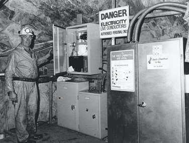 Photograph - AUSTIN COLLECTION: MINER STANDING AT SUB STATION