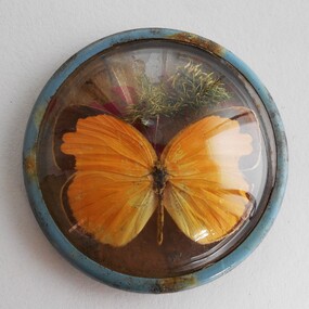 Ephemera - Small circular domed metal frame of yellow butterfly/moth