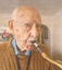 Colour photo of retired policeman Ivan Whyte playing his saxaphone