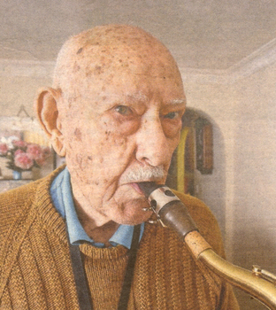 Colour photo of retired policeman Ivan Whyte playing his saxaphone