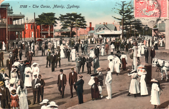 This coloured card shows a large crowd gathered along a broad seaside promenade; on the card is printed “1768 - The Corso, Manly, Sydney.”