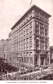 This black-and-white card shows the Commonwealth Bank building with a large crowd and procession in the surrounding streets; on the card is printed “COMMONWEALTH BANK OF AUSTRALIA, SYDNEY.”