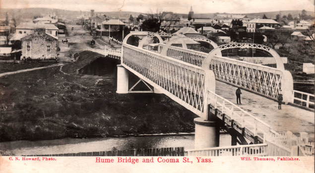 This black-and-white card shows an iron bridge leading into a town street; on the card is printed “C. N. Howard, Photo. Hume Bridge and Cooma St., Yass. Will. Thomson, Publisher.”