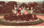 This coloured card shows visitors walking along a formal garden path bordered by flowerbeds, statues and ornamental urns; on the card is printed “BOTANICAL GARDENS, SYDNEY.” and “[Star Photo. Co., Copyright.”