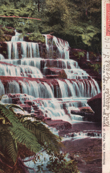 This coloured card shows a cascading waterfall surrounded by dense forest and ferns; on the card is printed “Britannia Falls, Valley of Waters, Blue Mountains, New South Wales.”