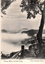 This black-and-white card shows mist rising through a mountainous valley framed by trees; on the card is printed “Rising Mists, Govetts Leap.” and “Kerry (Copyright) Sydney.”