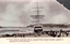 This black-and-white card shows a large sailing ship stranded on a beach surrounded by crowds; on the card is printed “ON MANLY BEACH (an Unusual Visitor).—The stranding of the French barque, ‘Vincennes,’ on the beach, usually devoted to the gambols of surf bathers, attracted thousands of sightseers to the ocean-side suburb.”