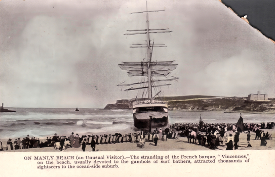 This black-and-white card shows a large sailing ship stranded on a beach surrounded by crowds; on the card is printed “ON MANLY BEACH (an Unusual Visitor).—The stranding of the French barque, ‘Vincennes,’ on the beach, usually devoted to the gambols of surf bathers, attracted thousands of sightseers to the ocean-side suburb.”