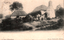 This black-and-white card shows a thatched bush homestead with people standing in the garden; on the card is printed “A Bush Homestead” and “Kerry (Copyright) Sydney.”