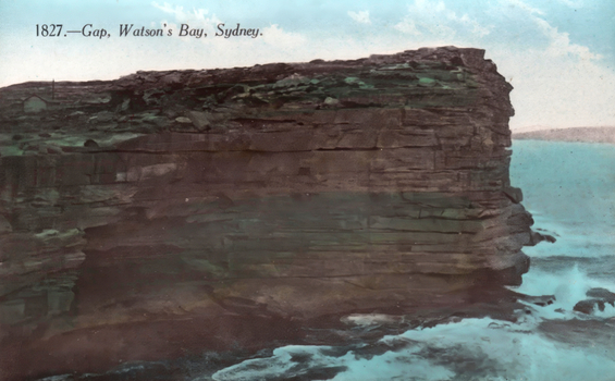 This coloured card shows a rocky coastal cliff above the sea; on the card is printed “1827.—Gap, Watson’s Bay, Sydney.”