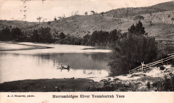 This black-and-white card shows two people in a boat on a river beside a wooded hillside; on the card is printed “A. J. Shearsby, photo.” and “Murrumbidgee River Yeumburra Yass”.
